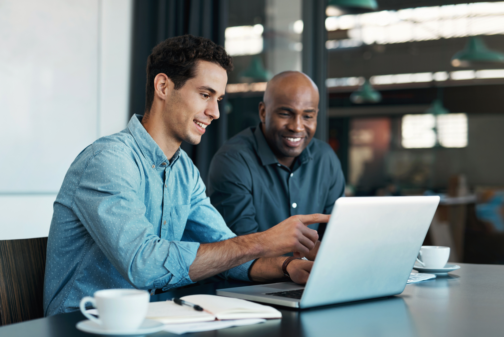 Two accountants looking at a computer