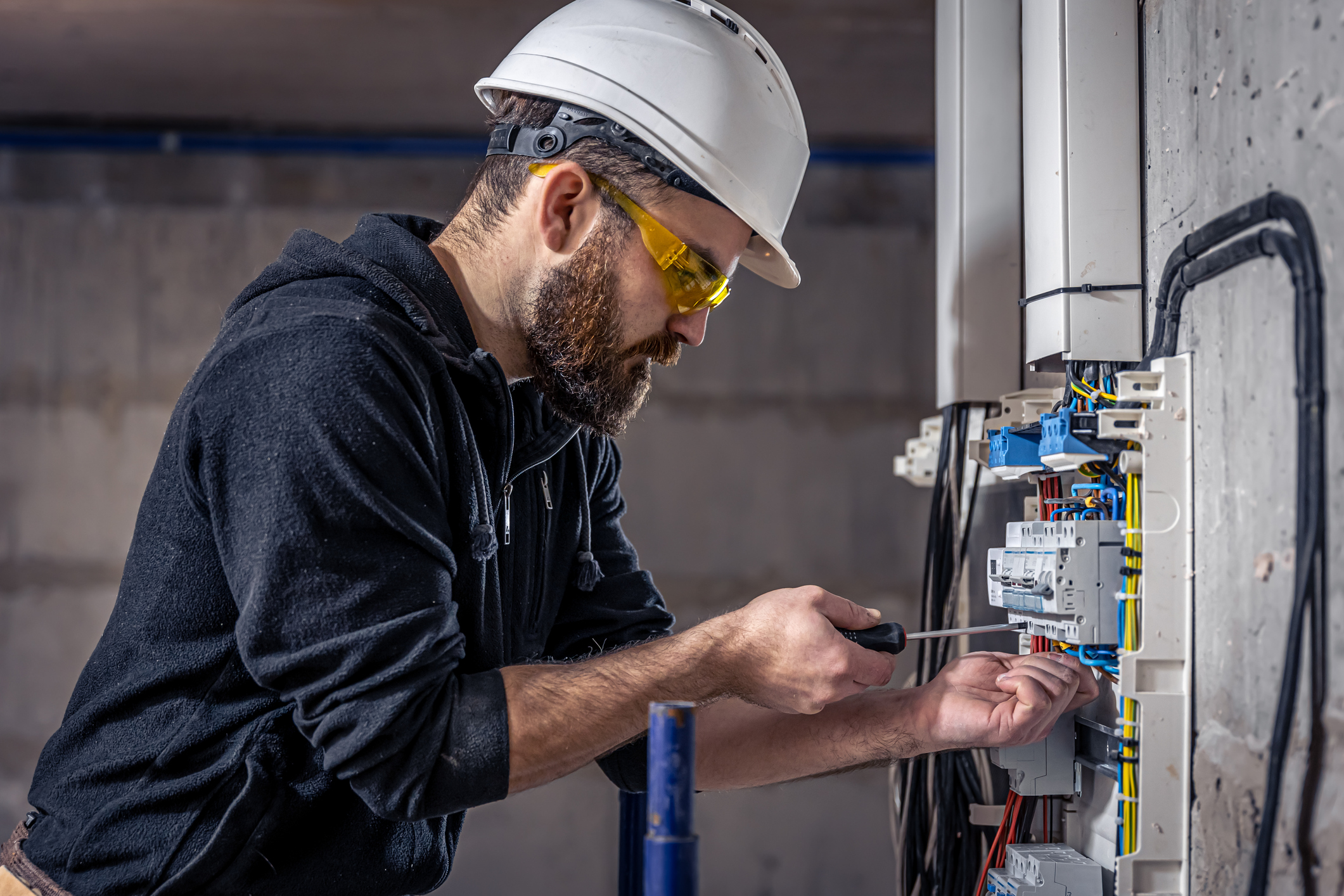 Electrician works on control panel