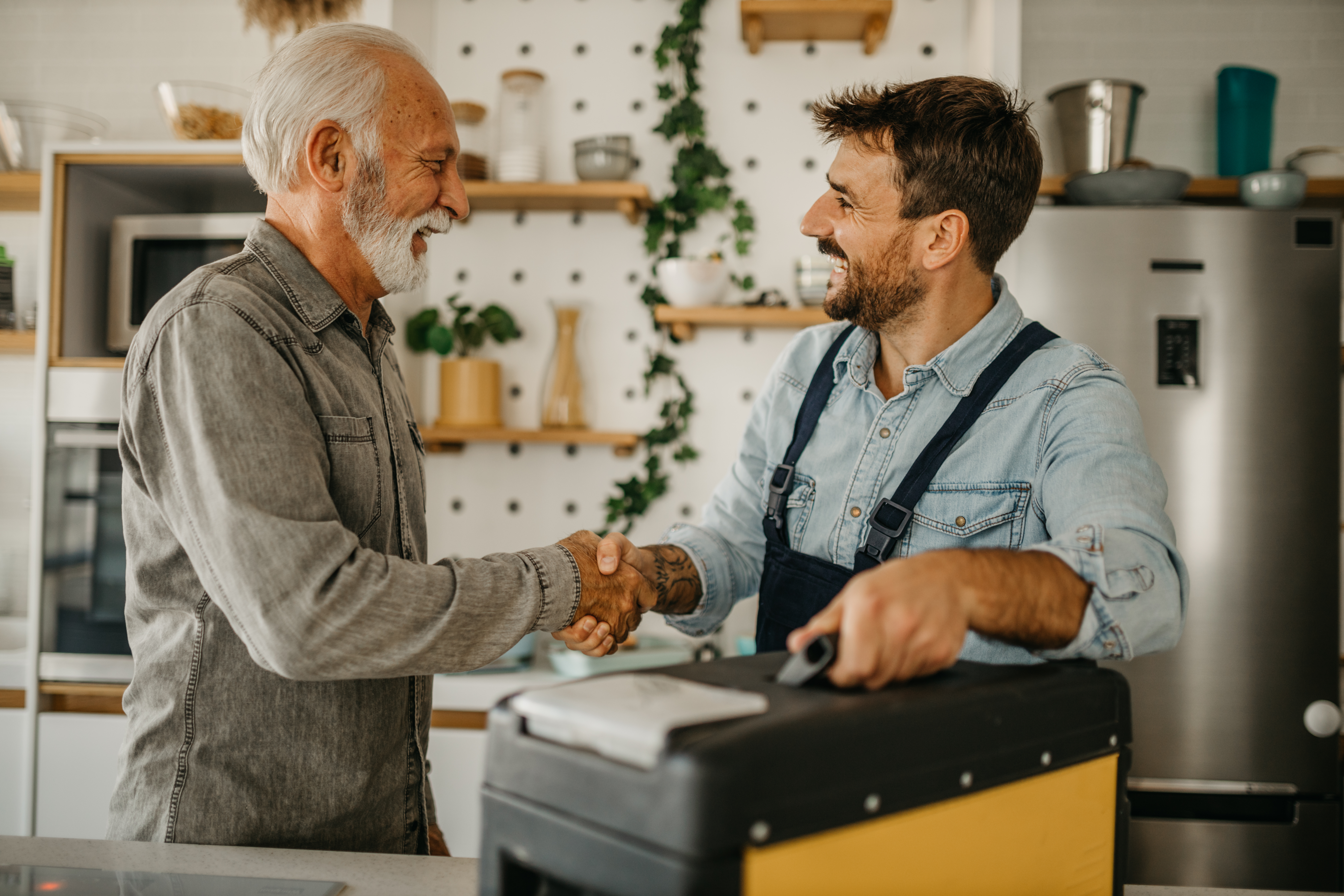 Handyman shakes hands with a customer