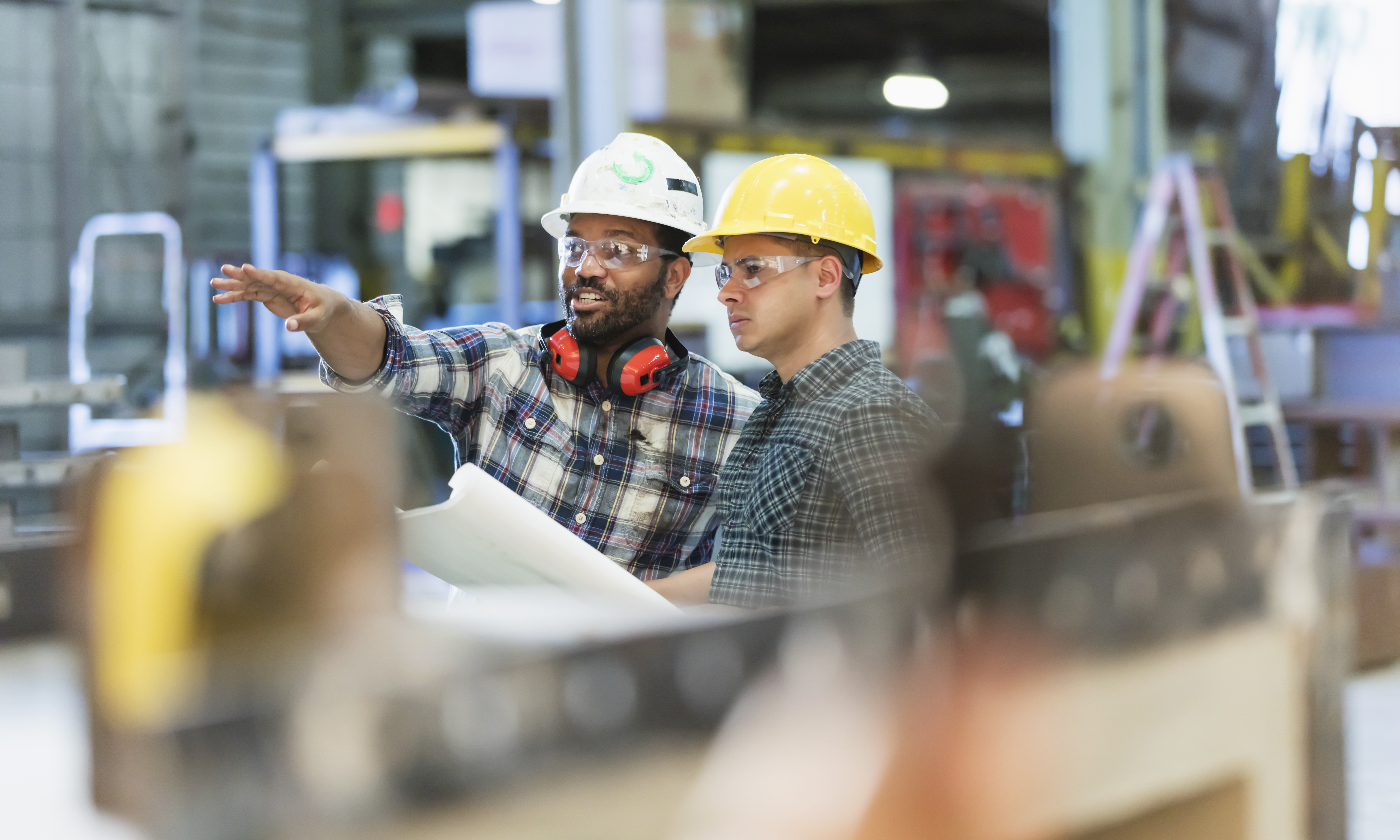 Two contractors reviewing building plans