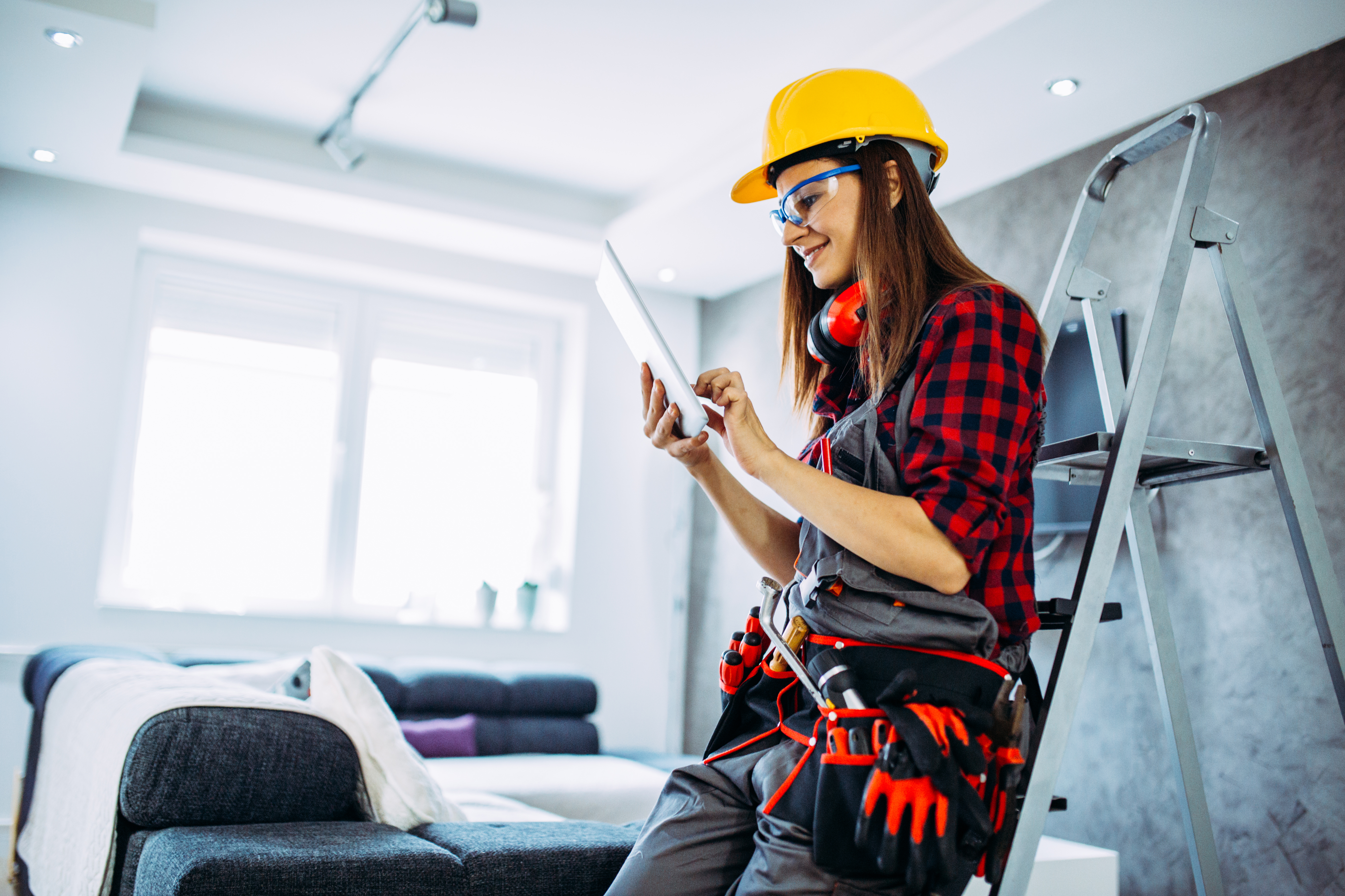 Female construction worker looking at a tablet