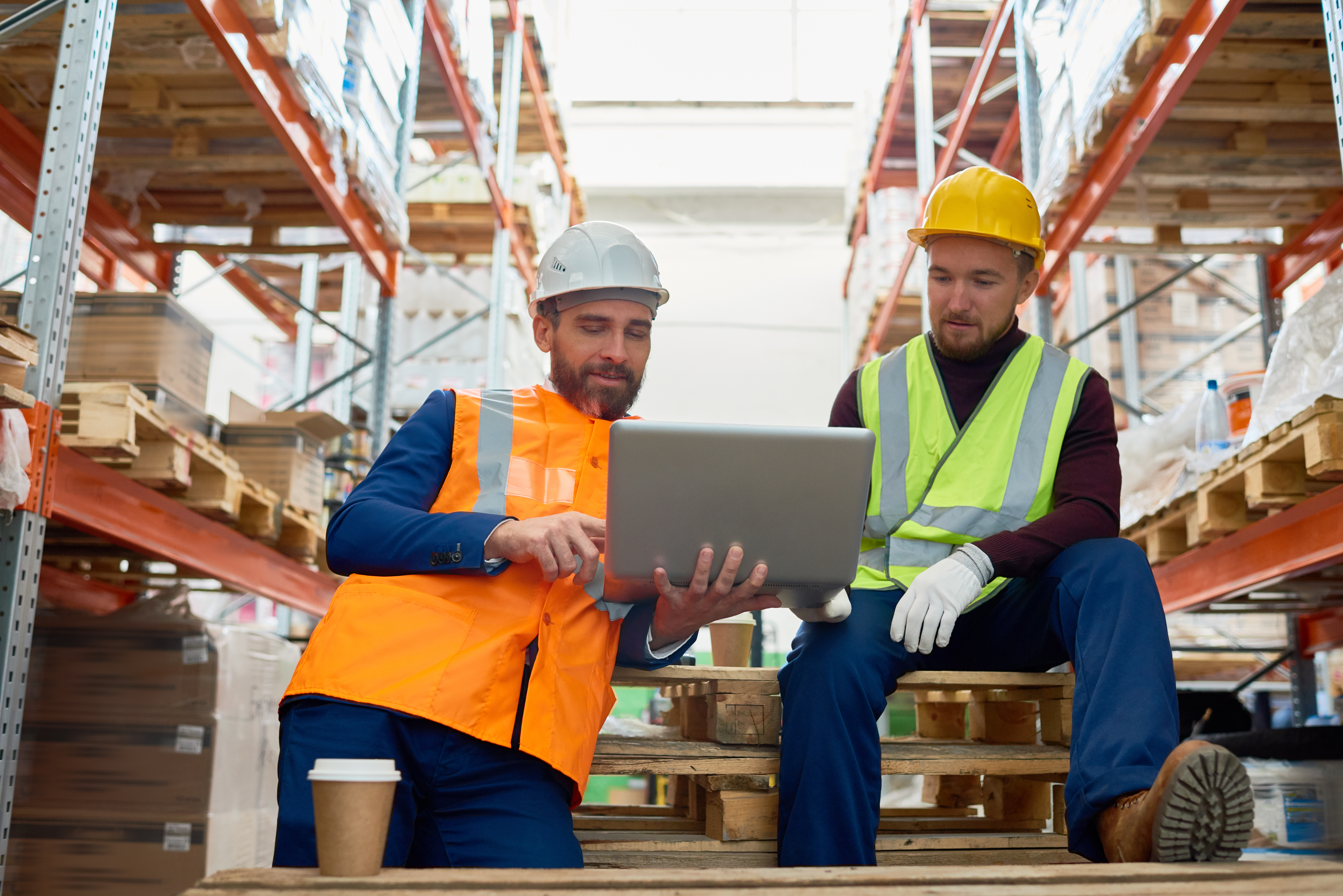 Two workers looking at a computer