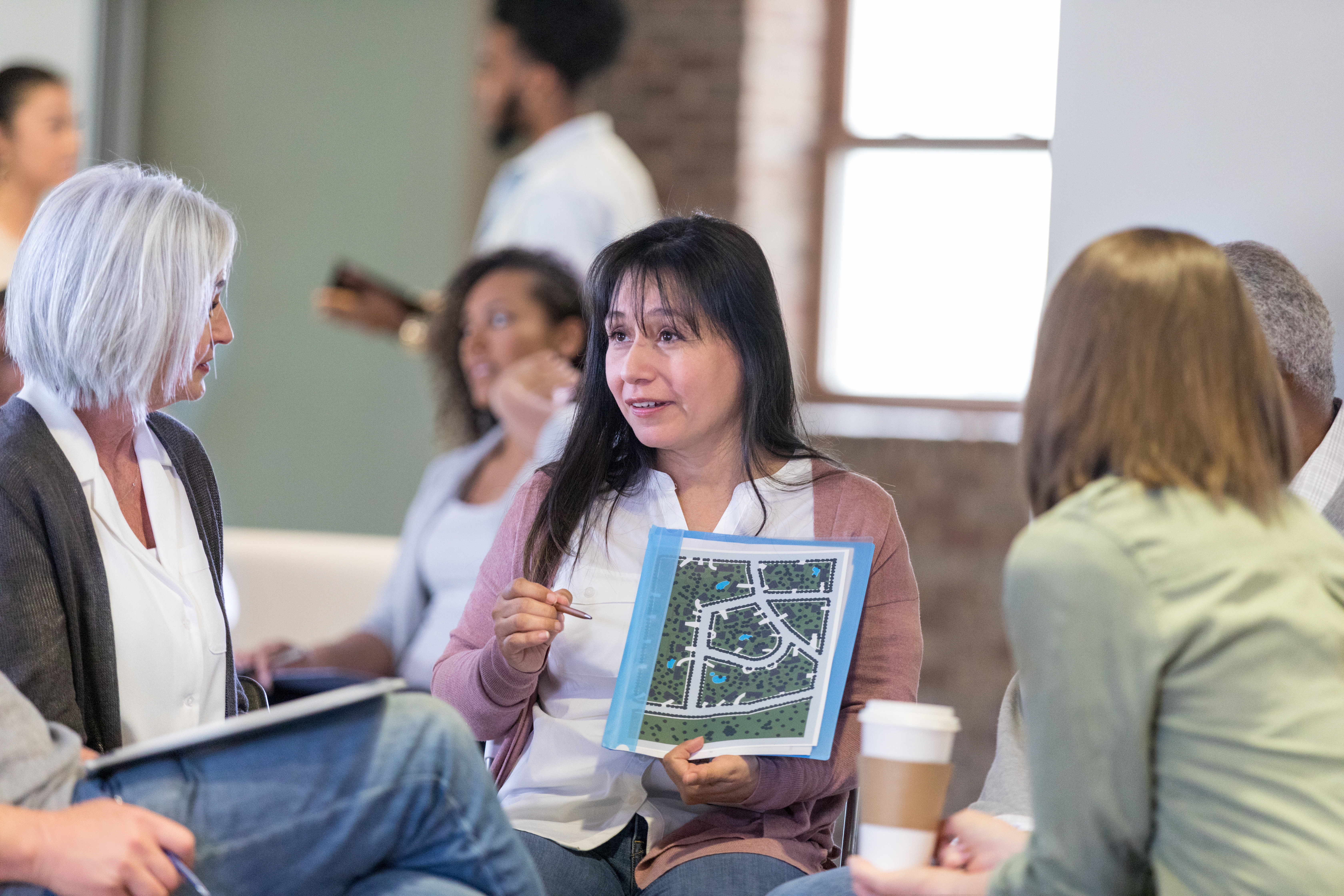 Person leading home owner association meeting