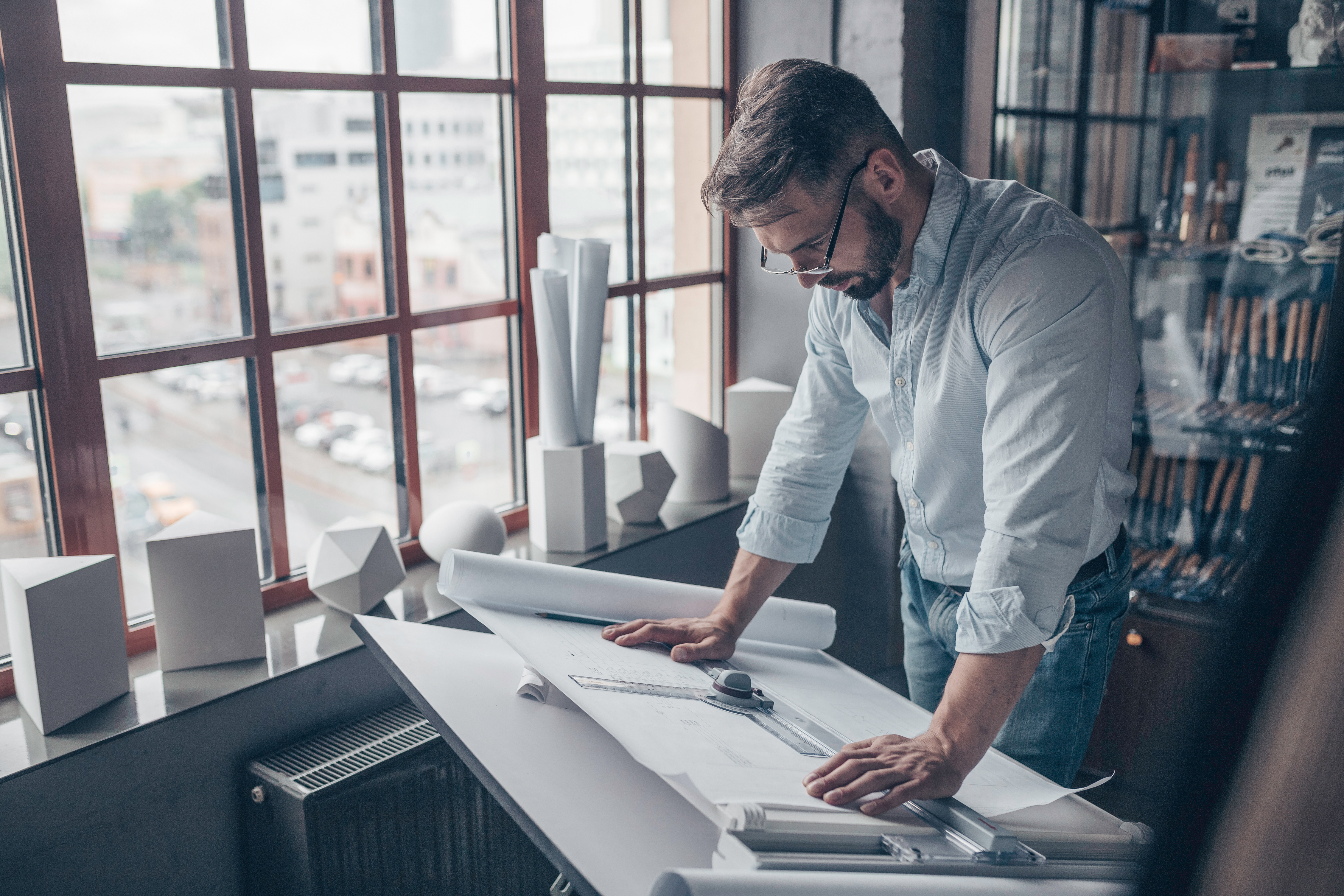 Working man with an architectural project indoors