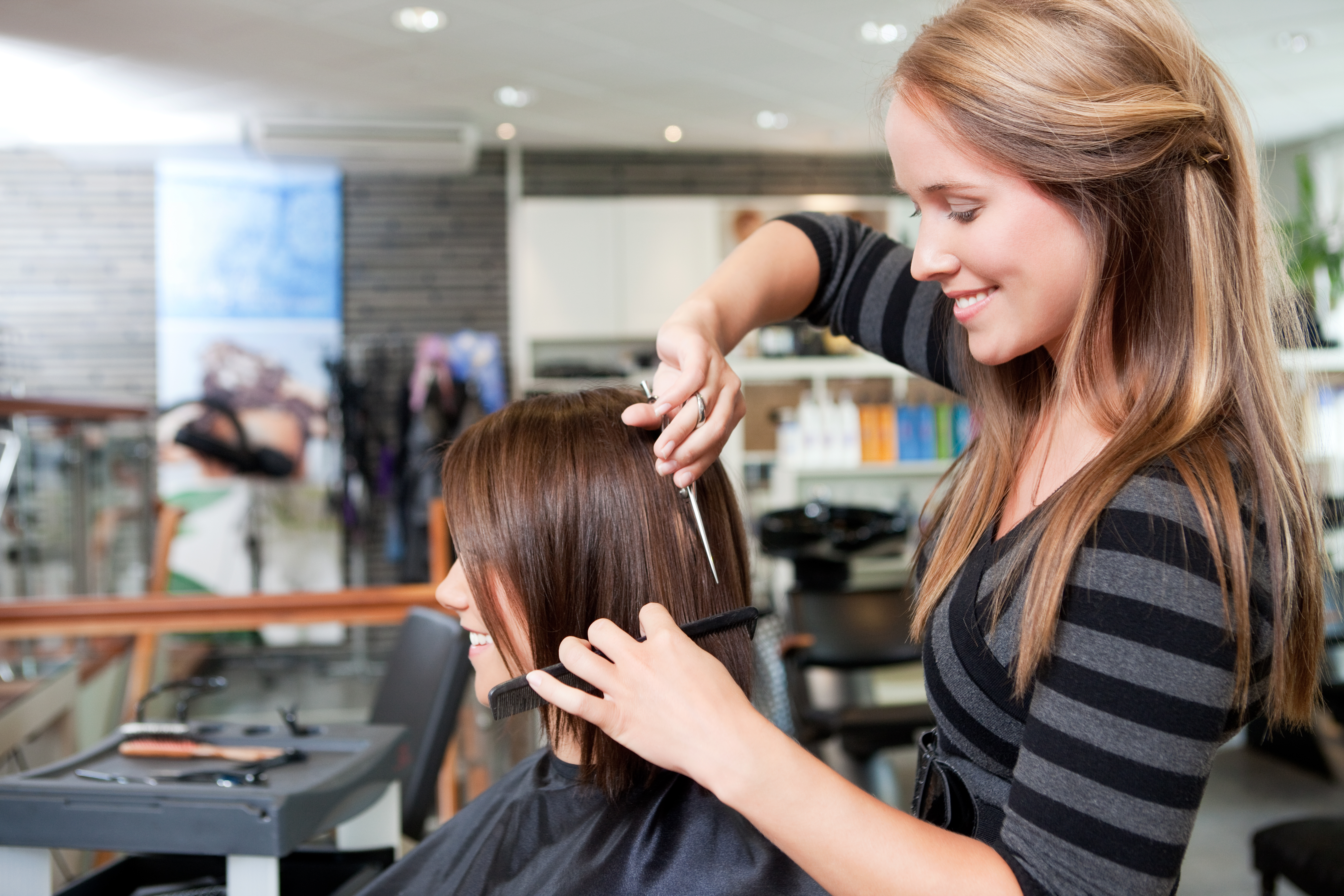 Haircutting lady lovingly cutting hair in a beautiful award winning studio