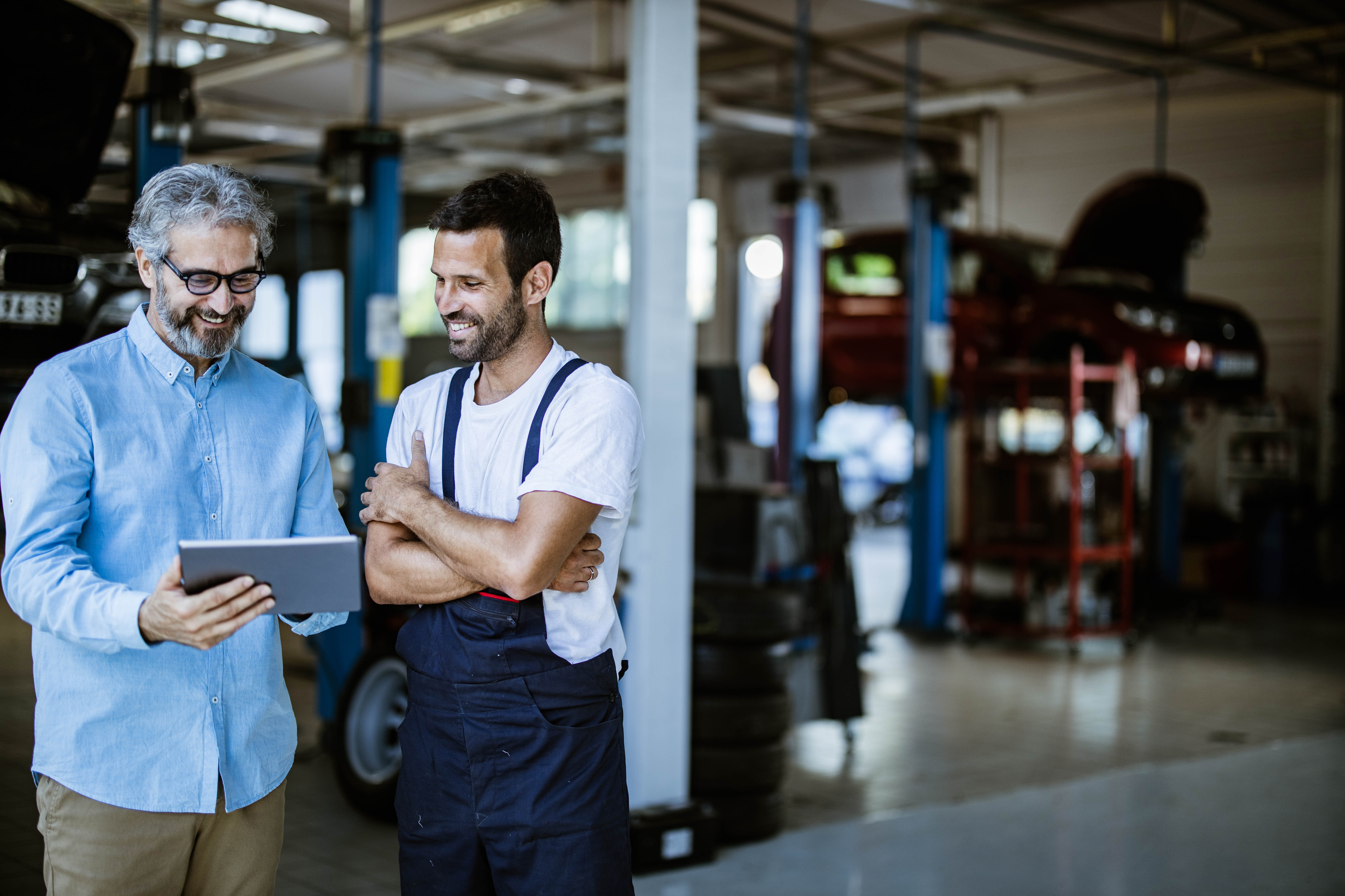 Mechanic reviewing estimate with customer