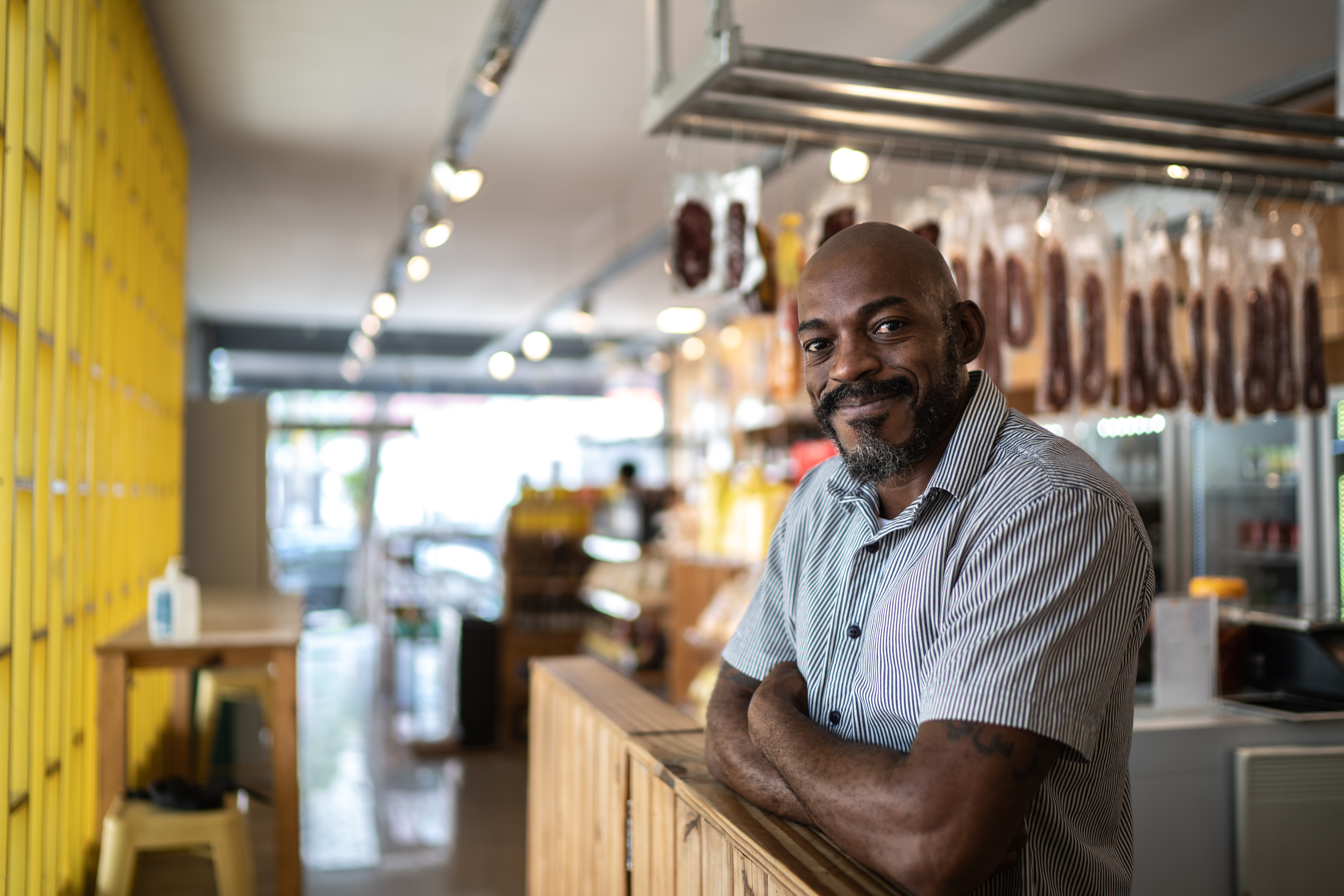 Butcher in shop smiling